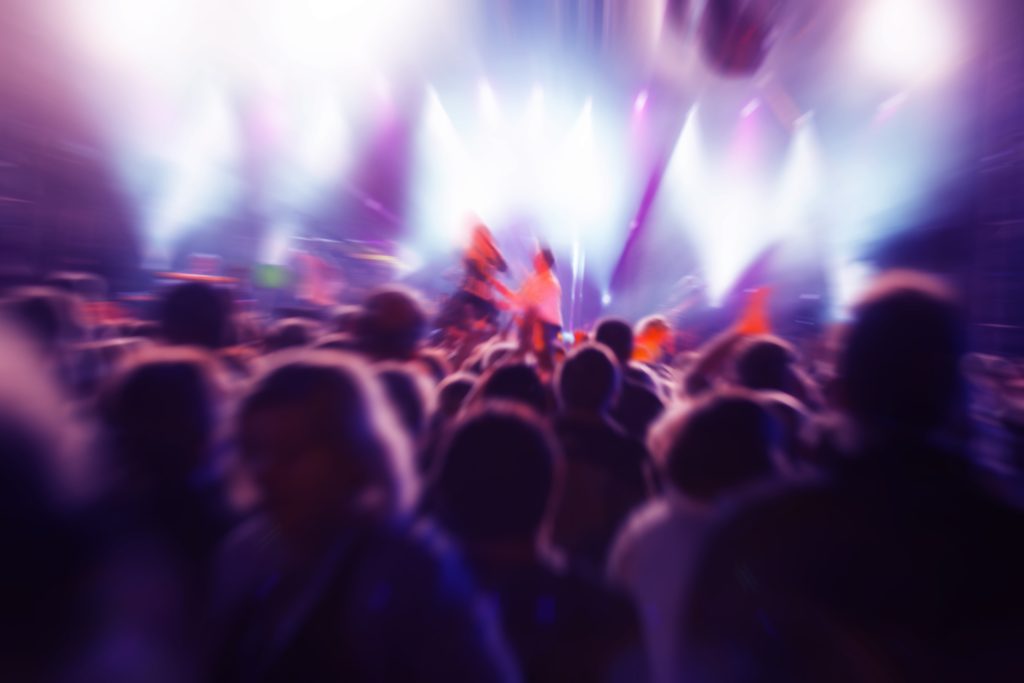 Energetic crowd dancing under colorful lights at Xtreme Club, the best nightclub in Dubai offering top nightlife Dubai experiences.